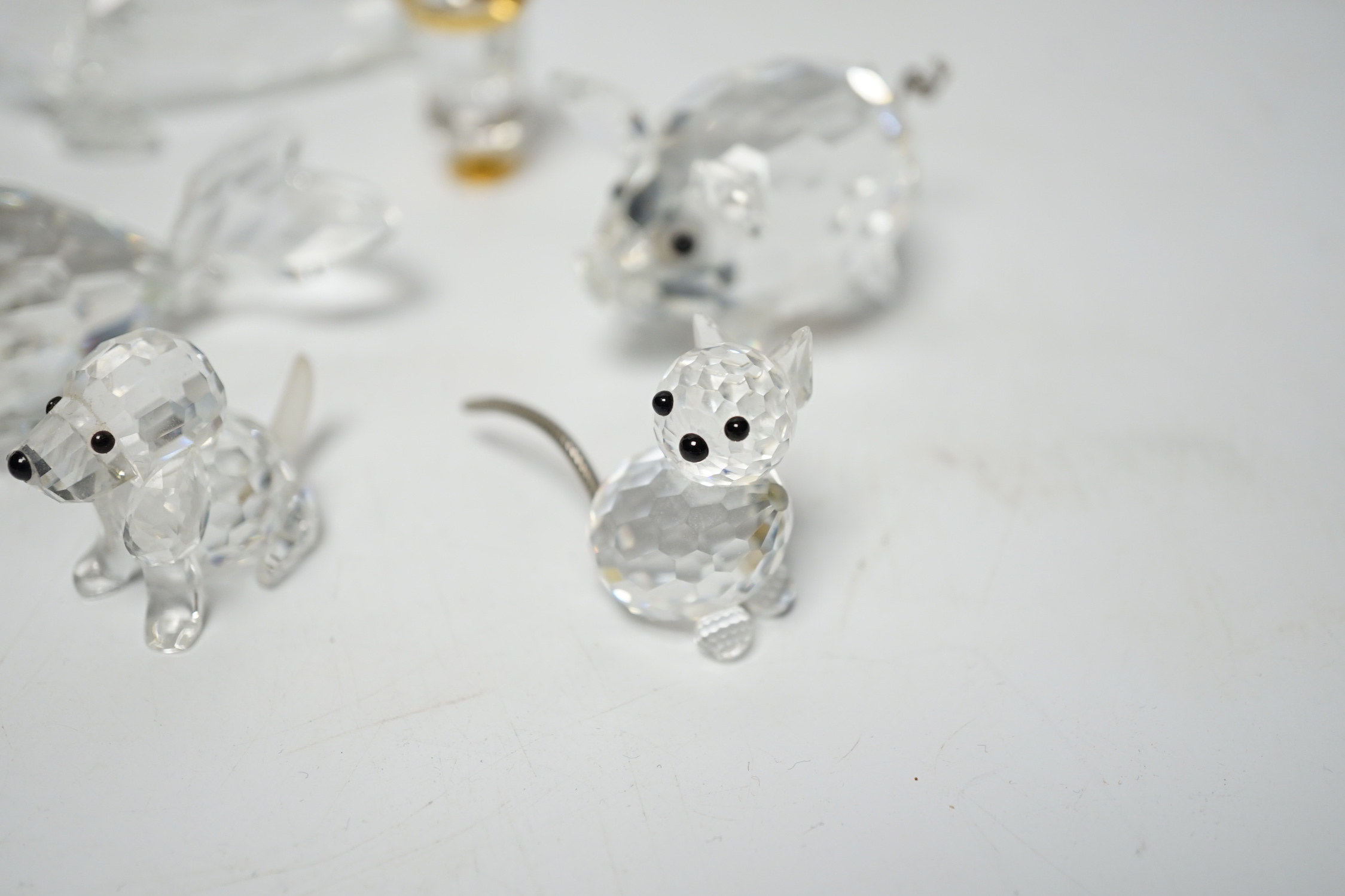 Eight Swarovski crystal animal ornaments and a miniature set of a Champagne cooler and two Champagne glass flutes, (11)